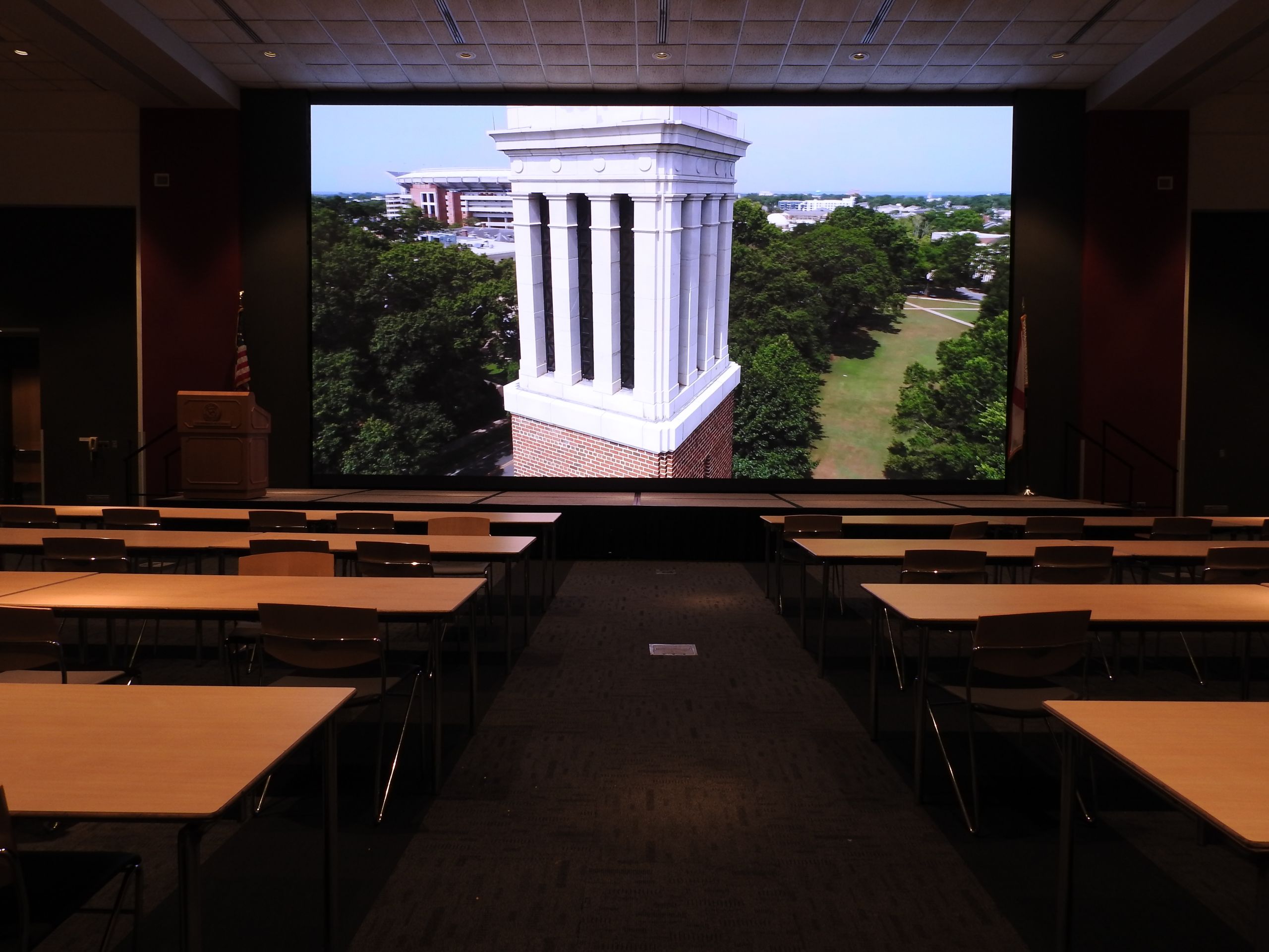 conference room with a screen depicting denny chimes